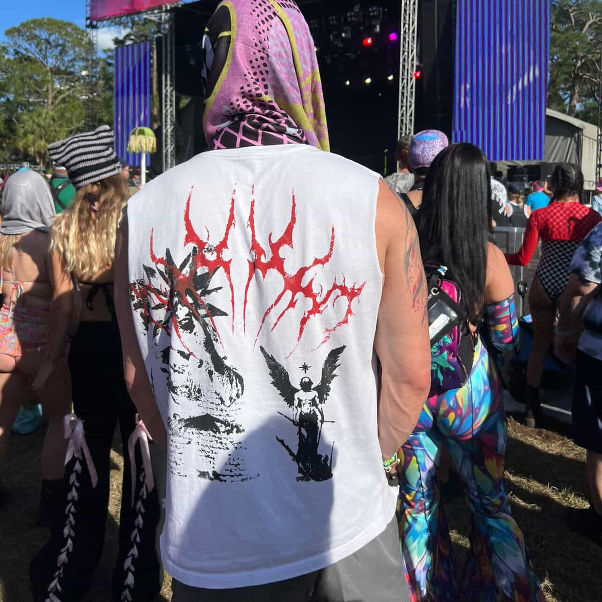 SERAPH sleeveless tee, white — worn at a festival